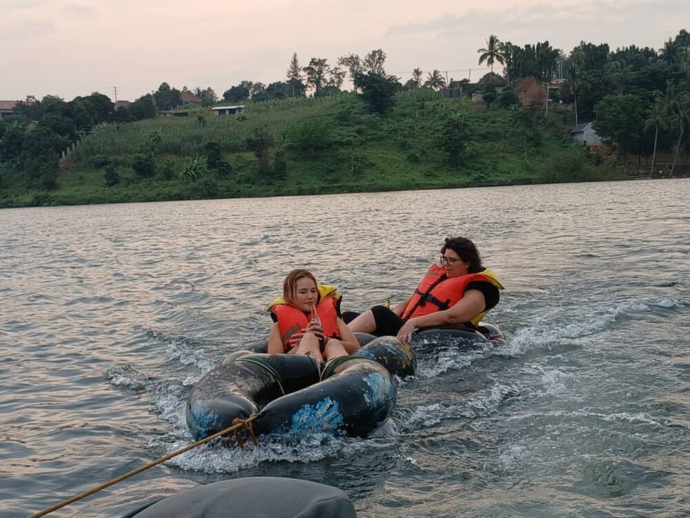Two travellers in life jackets floating on tubes down the Nile at Jinja
